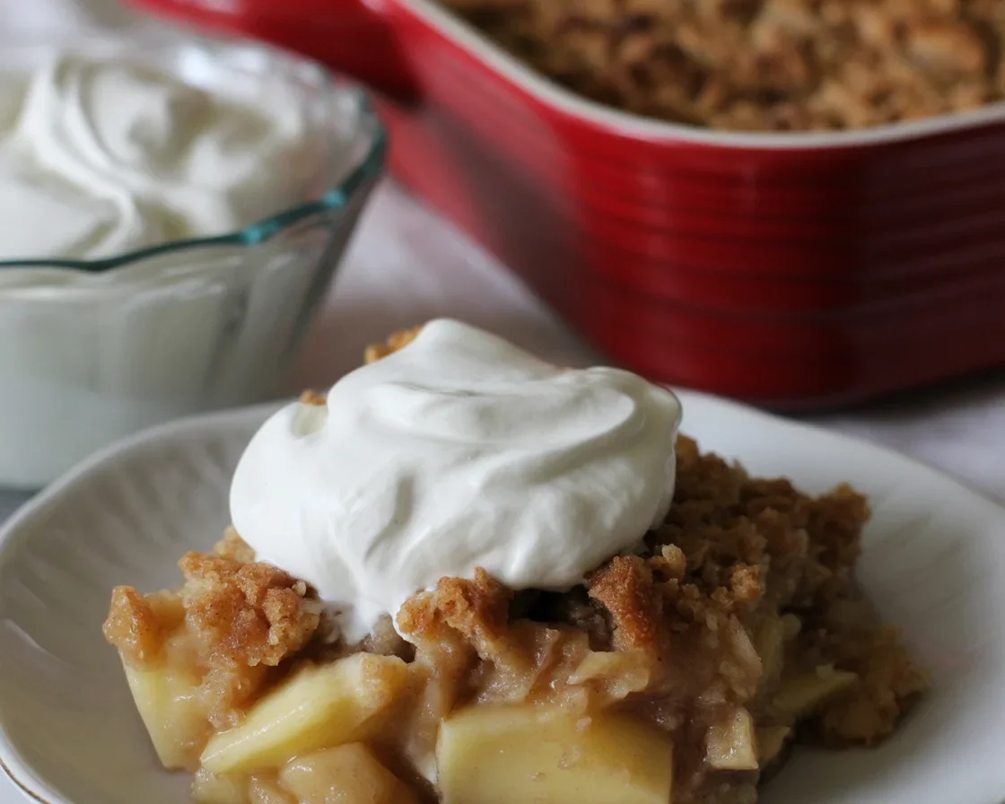 Delicious gluten free apple crisp served in a baking dish with a crunchy oat topping.