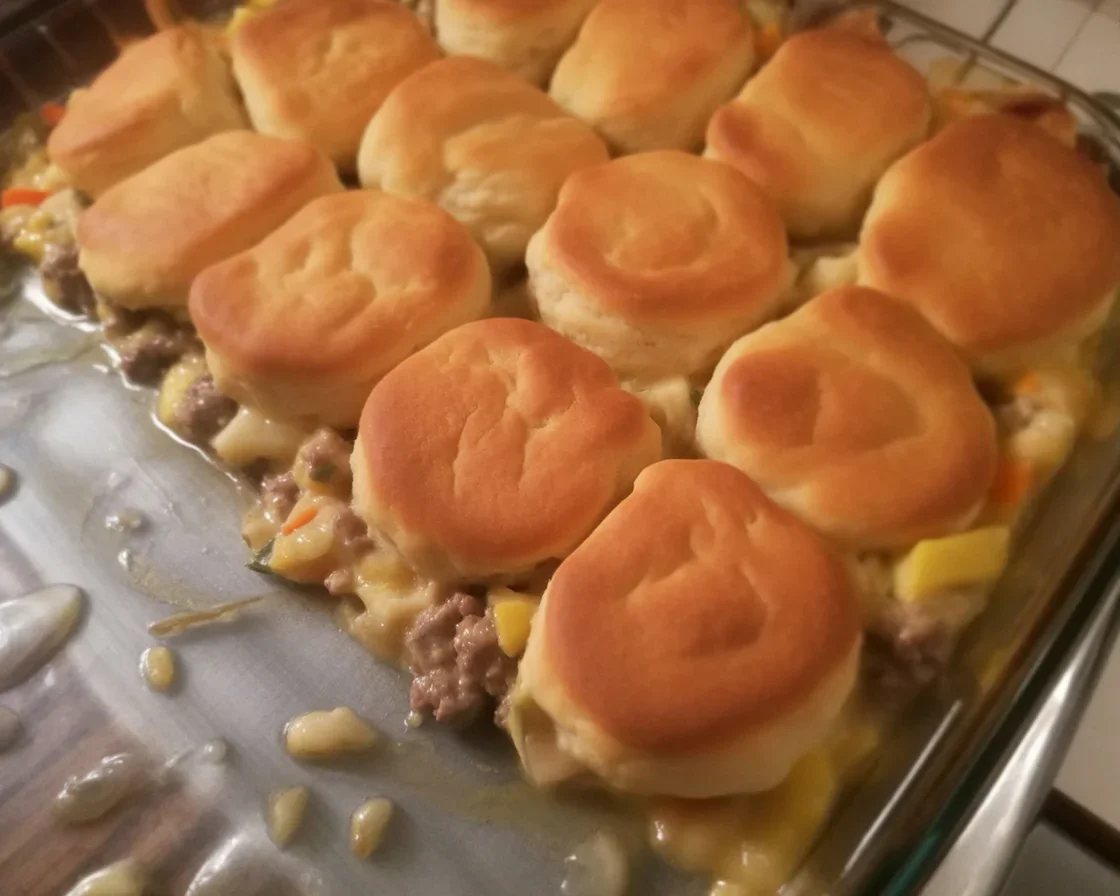 Delicious Retro Ground Beef Casserole with Biscuits topped and baked golden brown