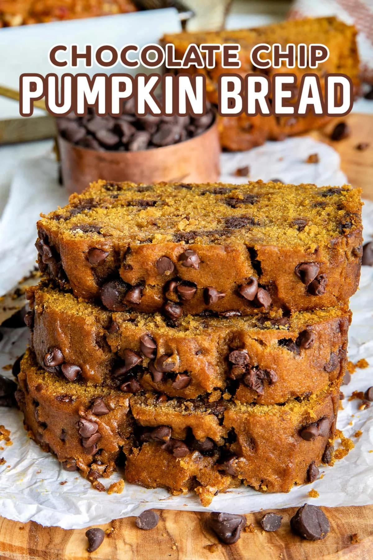 Moist and flavorful pumpkin chocolate chip bread slice on a wooden table.